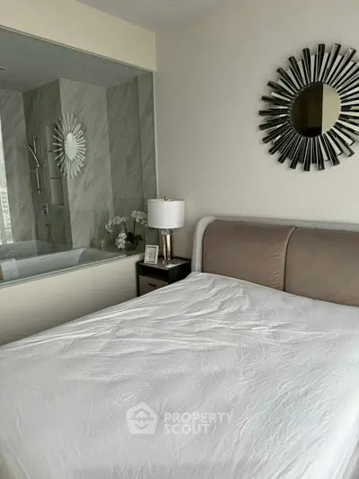 Luxurious bedroom with modern decor and ensuite bathroom featuring elegant bathtub.
