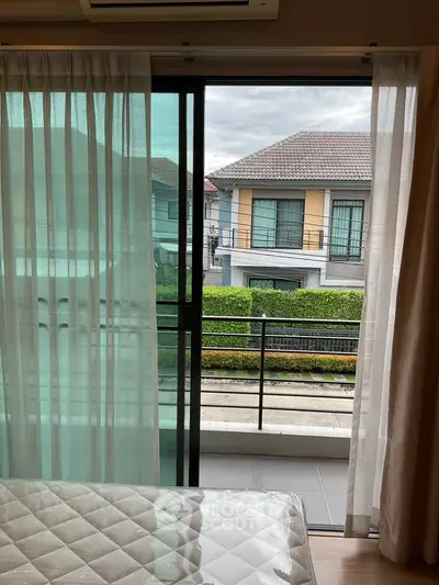 Bright bedroom with balcony view of modern suburban house