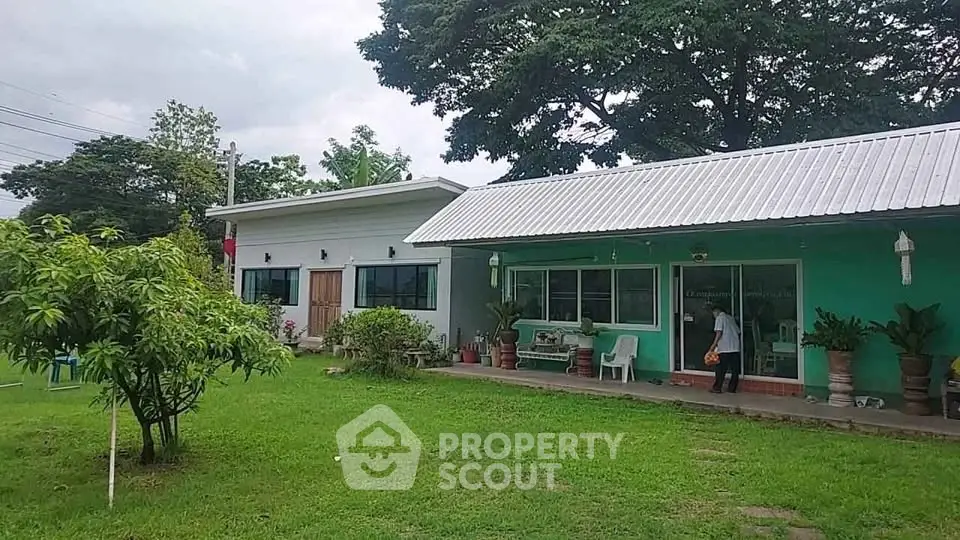 Charming single-story home with lush green garden and modern exterior design.