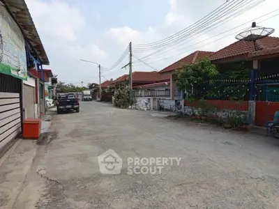 Charming suburban street with single-story homes and red-tiled roofs, perfect for family living.