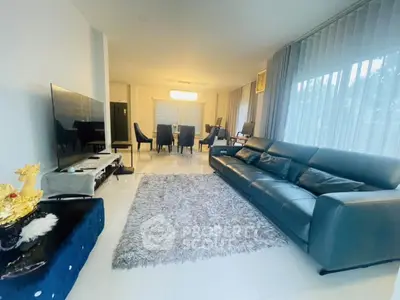 Spacious living room with modern decor and large windows for natural light