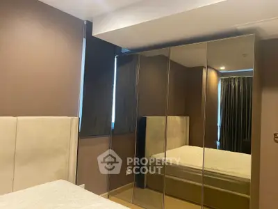 Modern bedroom with mirrored wardrobe and elegant design