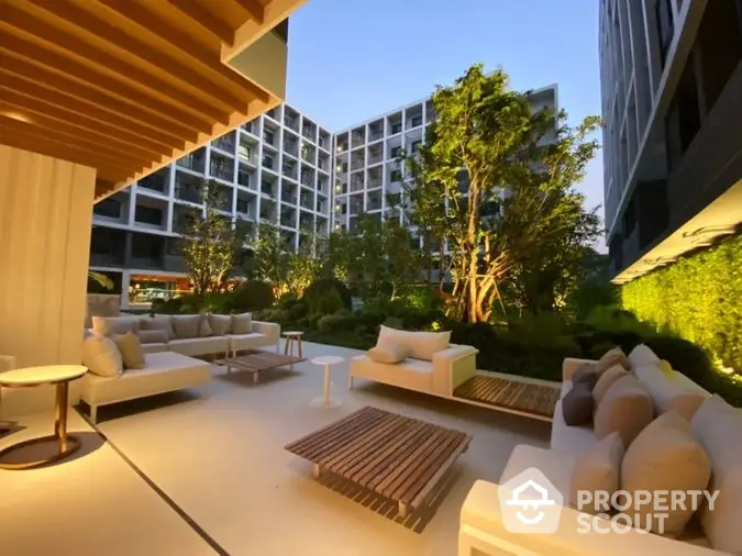 Luxurious outdoor lounge area with plush seating and modern design, nestled within a high-end residential complex, perfect for relaxation and social gatherings.