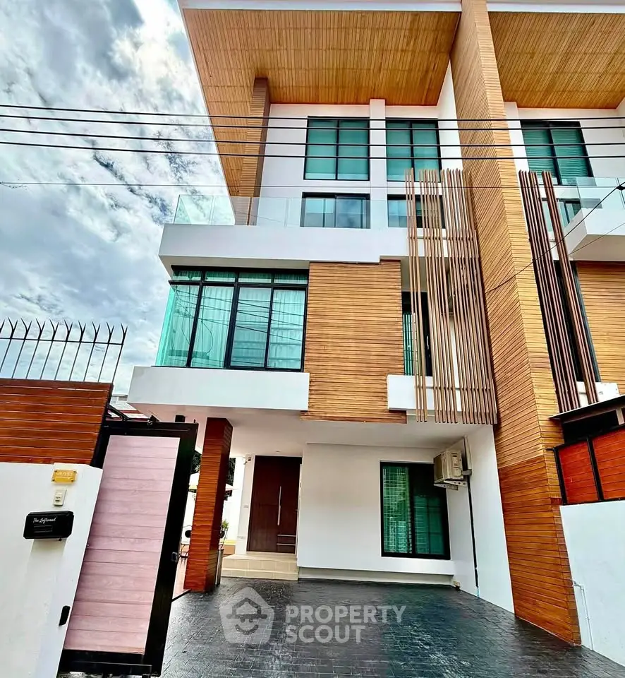 Modern multi-story building with wood accents and large windows, showcasing contemporary architecture.