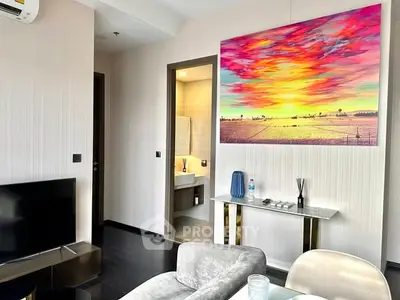 Modern living room with vibrant artwork and sleek furniture