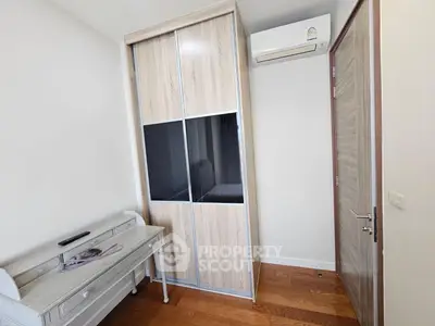 Modern bedroom with wooden floor and built-in wardrobe