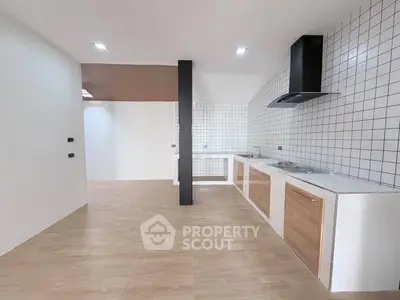Modern kitchen with sleek design, open layout, and stylish tiled backsplash, perfect for contemporary living.