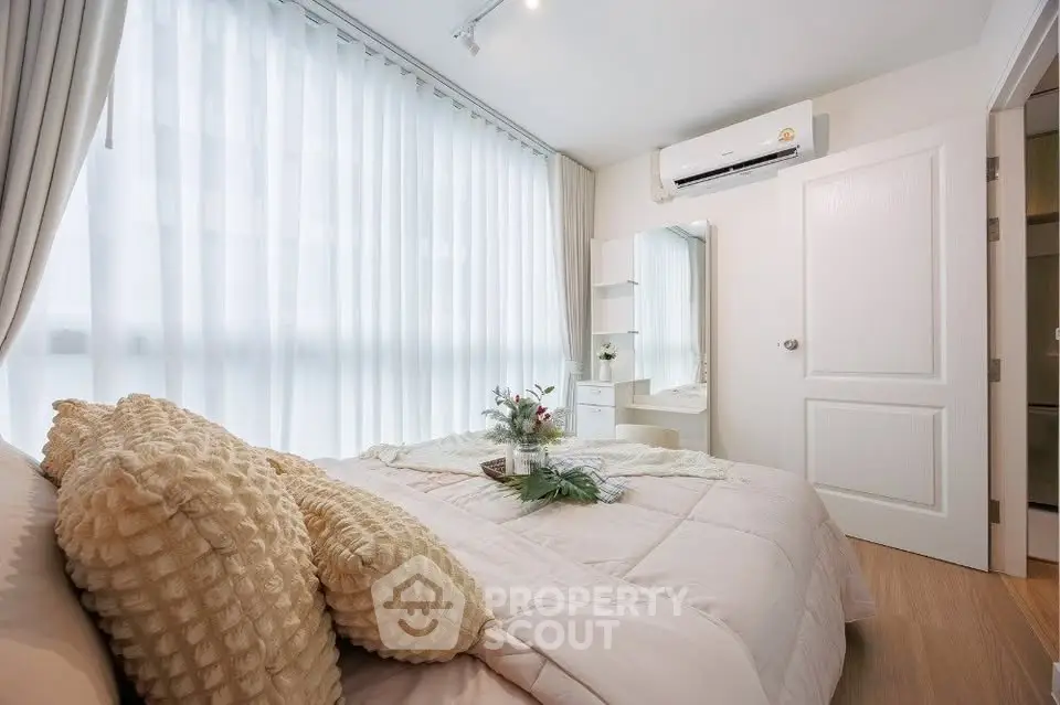 Cozy bedroom with soft lighting and elegant decor, featuring a comfortable bed and stylish vanity.