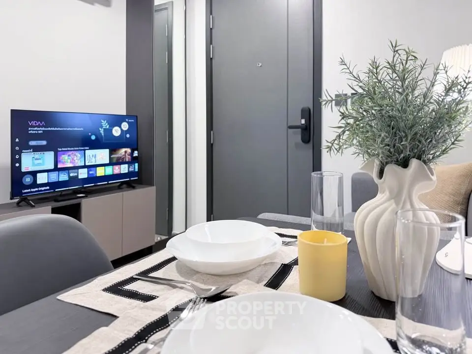 Modern living room with dining setup and smart TV, perfect for cozy urban living.