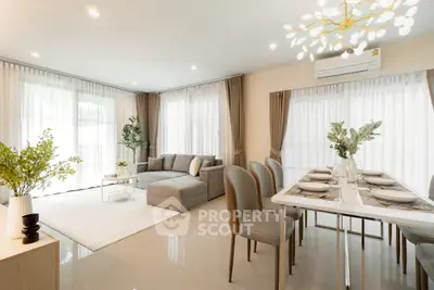 Spacious modern living and dining area with elegant decor and natural light.