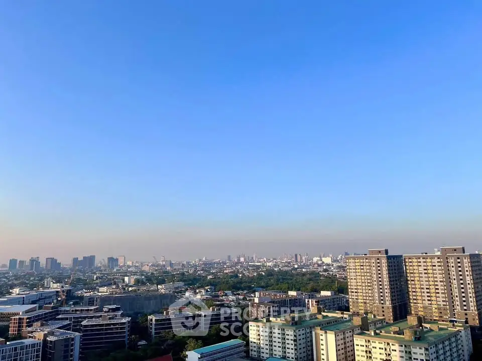 Stunning cityscape view from high-rise building showcasing urban skyline and clear blue sky.