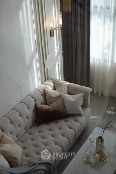 Elegant living room with plush sofa and soft lighting, perfect for relaxation and comfort.