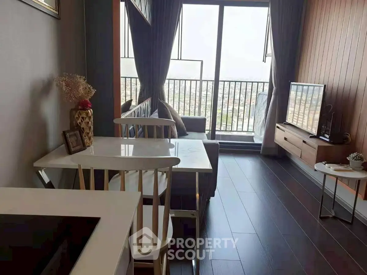 Modern living room with balcony view, sleek furniture, and natural light.