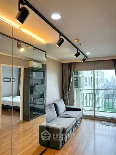 Modern living room with city view and mirrored wall in high-rise apartment