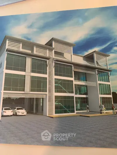 Modern commercial building with glass facade and ample parking space