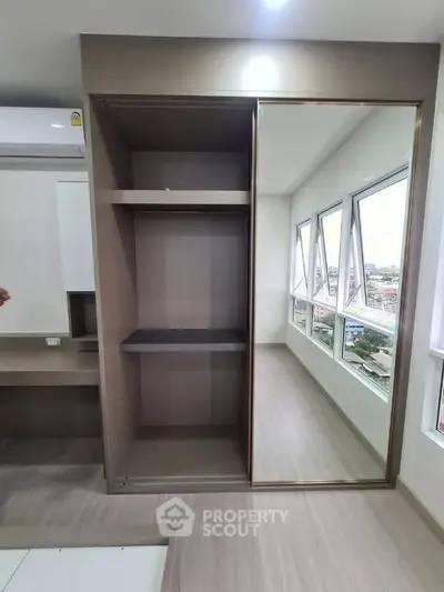 Modern bedroom with built-in wardrobe and panoramic city view