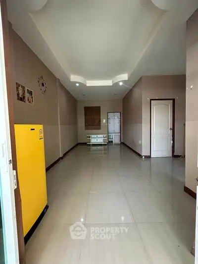 Spacious interior with modern ceiling design and glossy tiled flooring