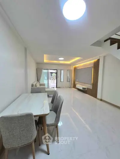 Spacious modern living room with elegant dining area and stylish decor