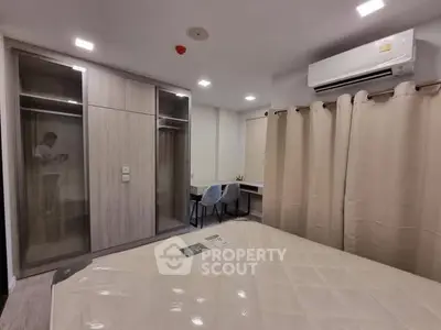 Modern bedroom with built-in wardrobe and air conditioning