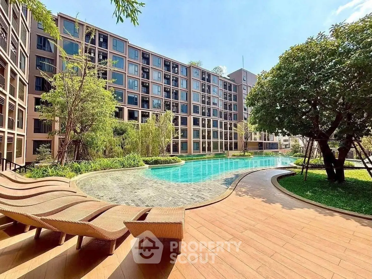 Luxurious apartment complex with stunning pool and lush greenery, perfect for relaxation and leisure.