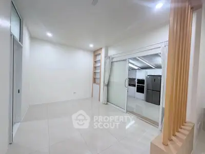 Spacious modern living room with open kitchen and sleek appliances