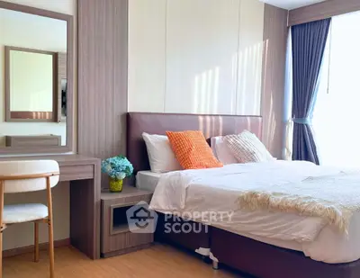 Modern bedroom with stylish decor and natural light, featuring a cozy bed and elegant furnishings.