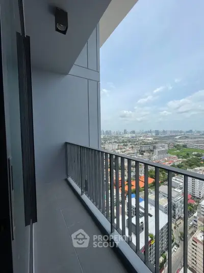 Spacious balcony with stunning city view in modern high-rise apartment.