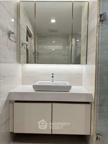 Modern bathroom with sleek vanity and mirrored cabinet
