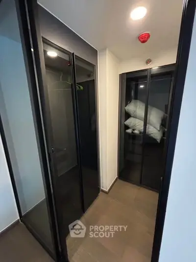 Modern storage area with sleek glass doors and ample space for organization.