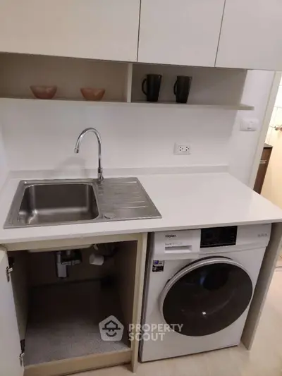 Modern kitchen with integrated washing machine and sleek cabinetry