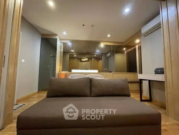 Modern bedroom with stylish decor and ambient lighting, featuring a comfortable bed and sleek furnishings.