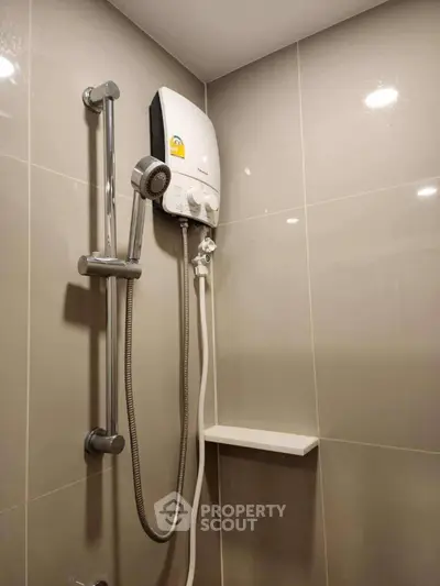 Modern bathroom with sleek shower and water heater, perfect for a comfortable living experience.