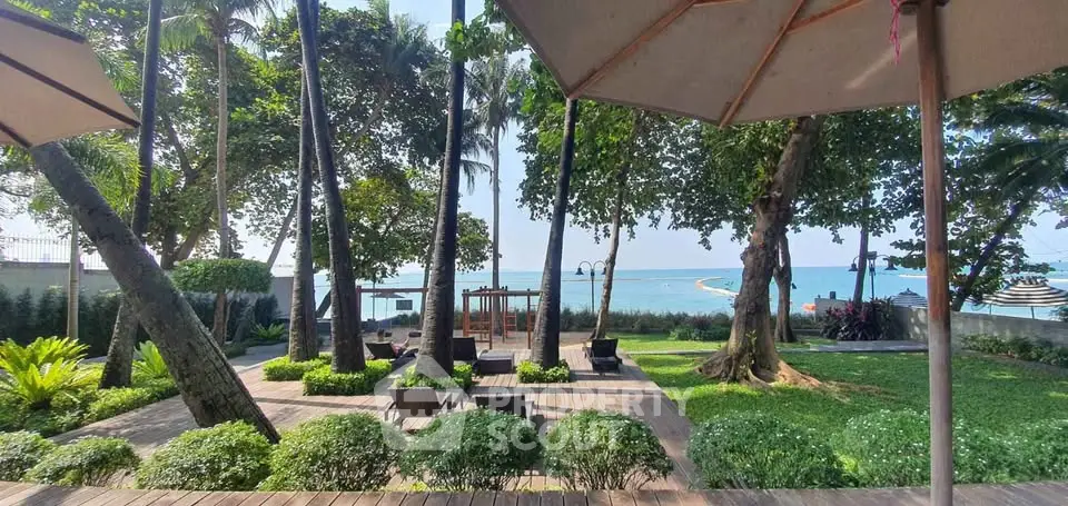 Stunning beachfront garden with lush greenery and ocean view, perfect for relaxation and leisure.
