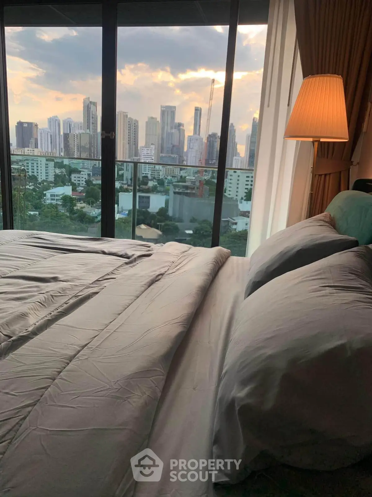 Luxurious bedroom with stunning city skyline view from large window