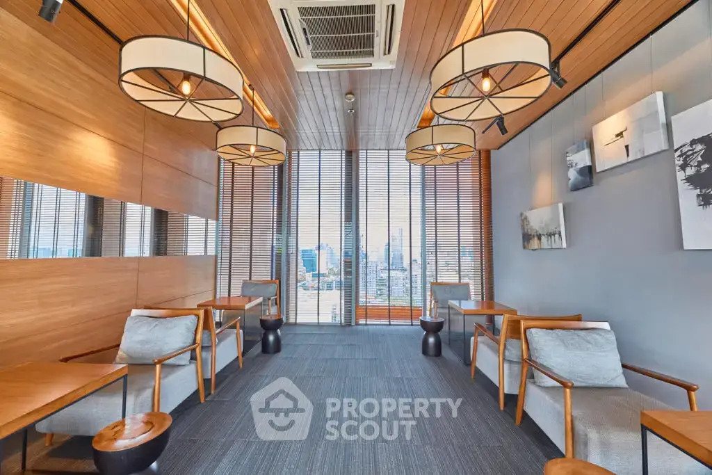 Modern co-working space with city view, stylish wooden decor, and comfortable seating.