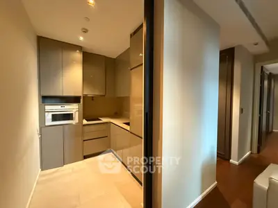 Modern kitchen with sleek cabinetry and built-in appliances in a contemporary apartment.