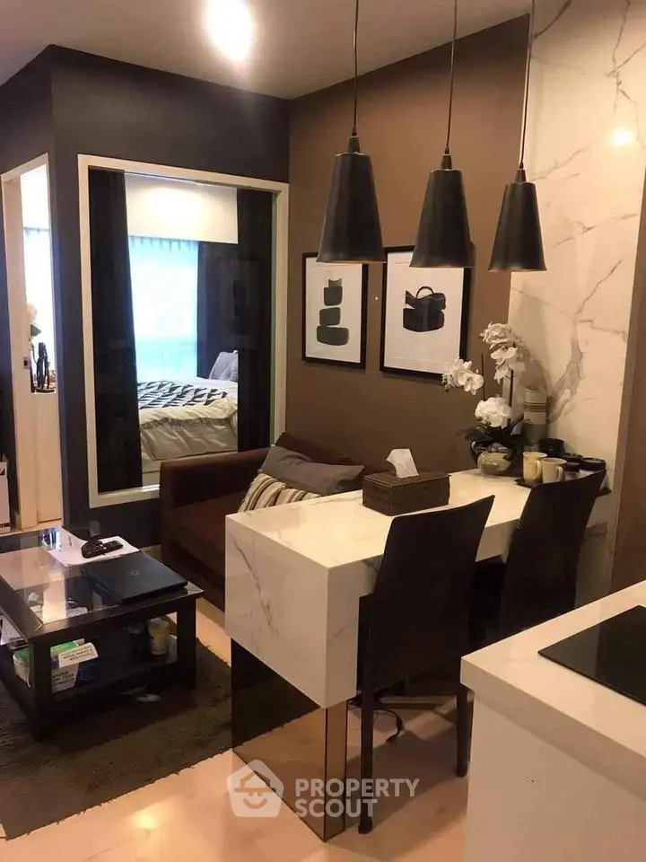 Modern living room with stylish decor and open layout, featuring elegant lighting and cozy seating area.