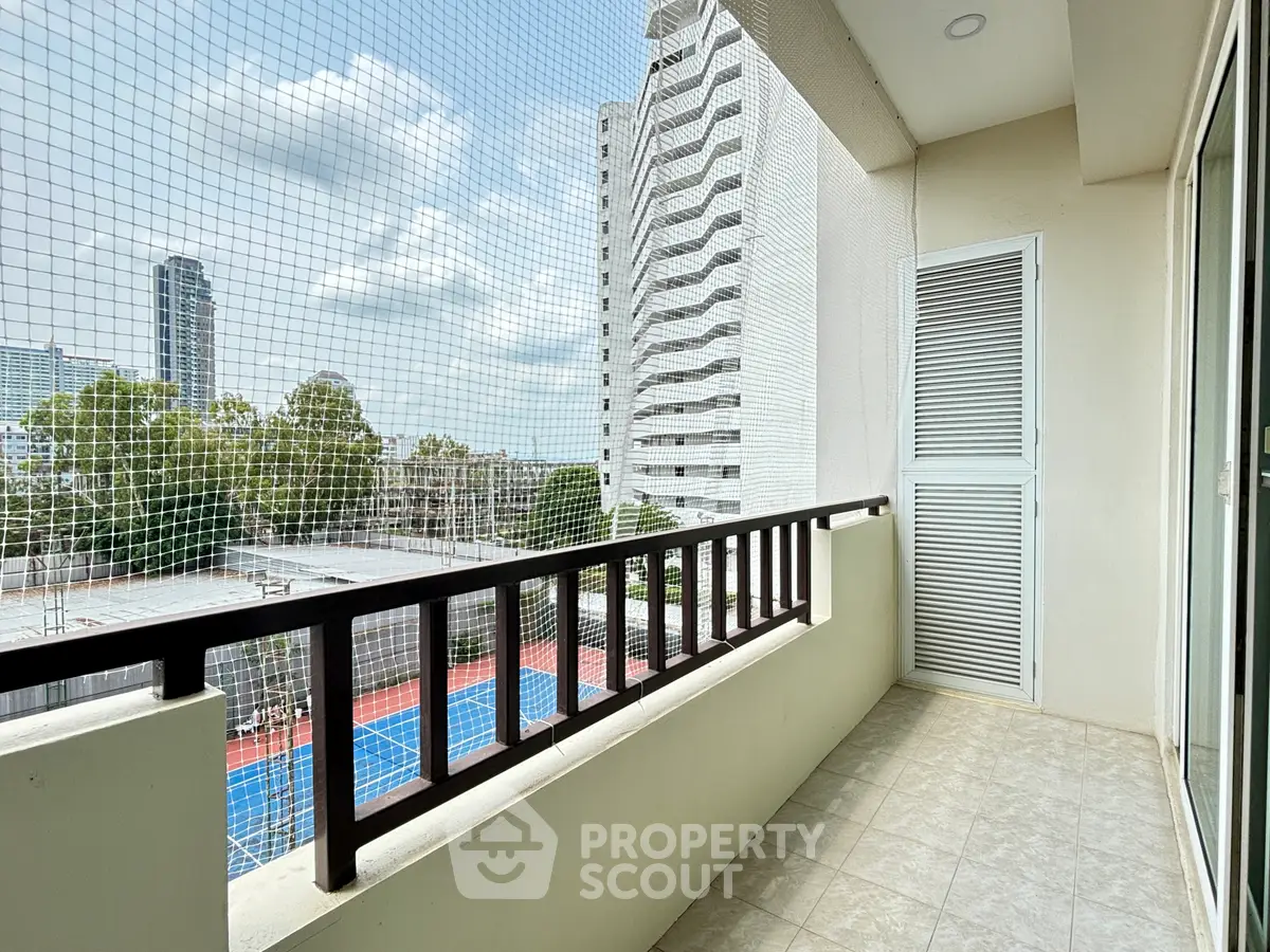 Spacious balcony with city view in modern apartment building