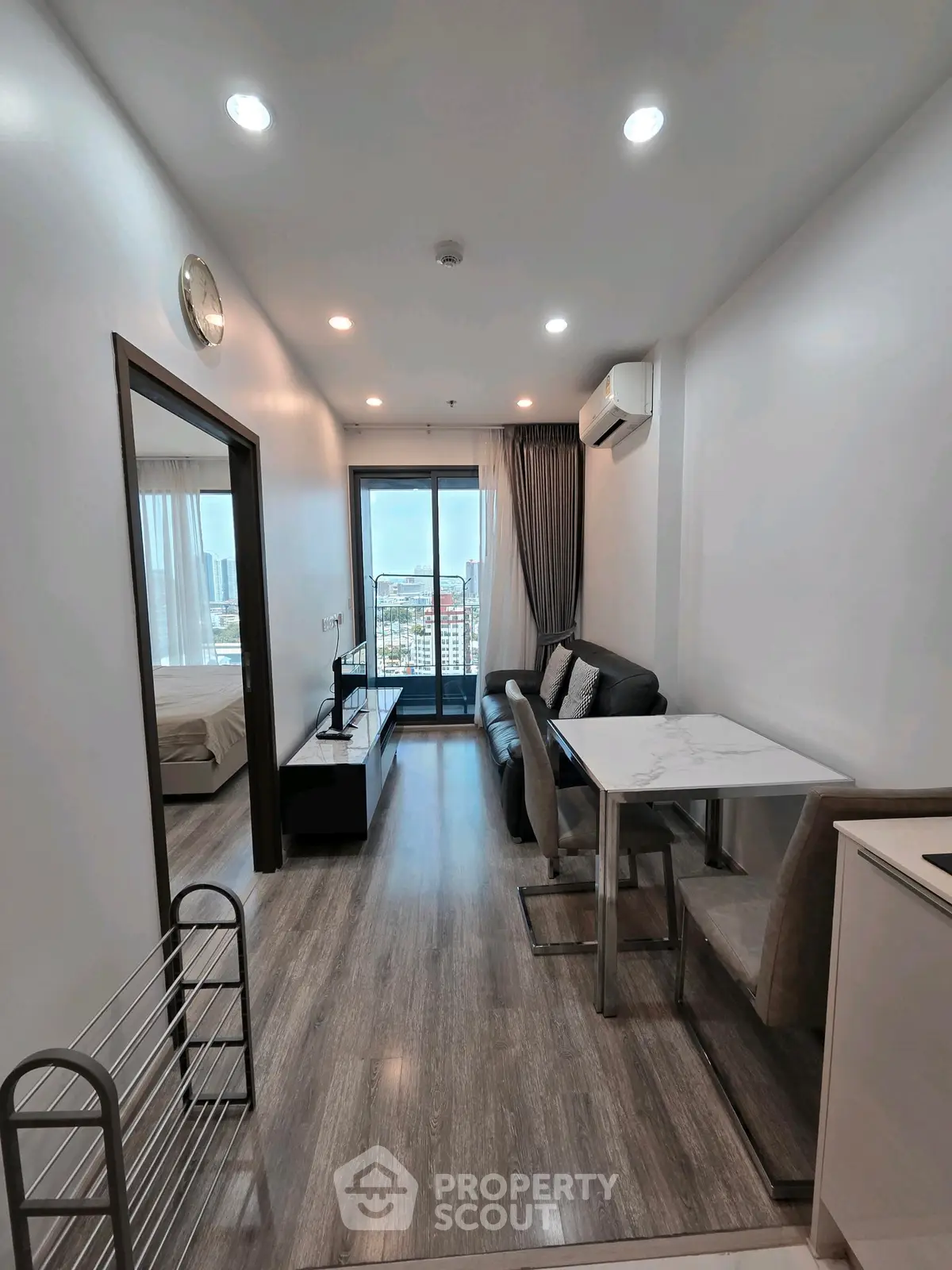 Modern apartment living room with sleek design and city view balcony