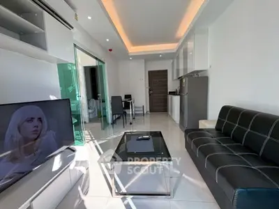 Modern living room with sleek furniture and open kitchen layout