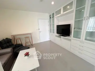 Modern living room with sleek furniture and built-in storage, perfect for urban living.