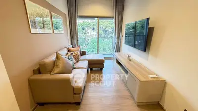 Modern living room with large window and stylish furniture, offering a cozy and inviting atmosphere.