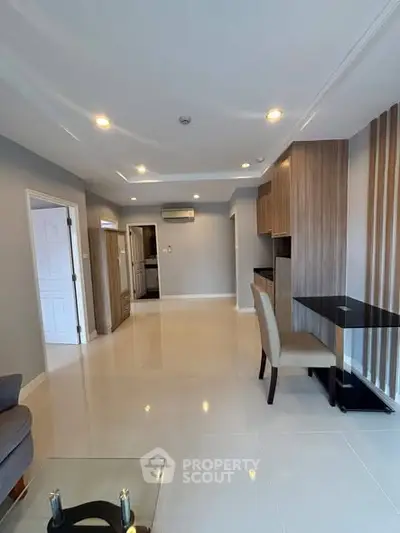 Modern living room with sleek design and open layout, featuring stylish furniture and ample natural light.