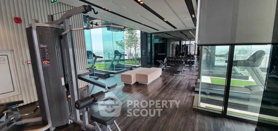 Luxurious high-rise gym with panoramic city views and modern equipment