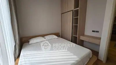 Cozy bedroom with natural light and built-in wooden wardrobe