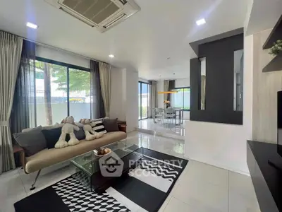 Modern living room with stylish decor and large windows offering natural light