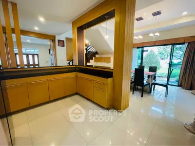 Spacious open-plan living area with modern dining space and garden view.
