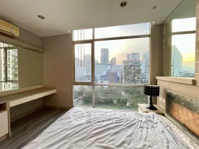 Modern bedroom with stunning city view and large windows