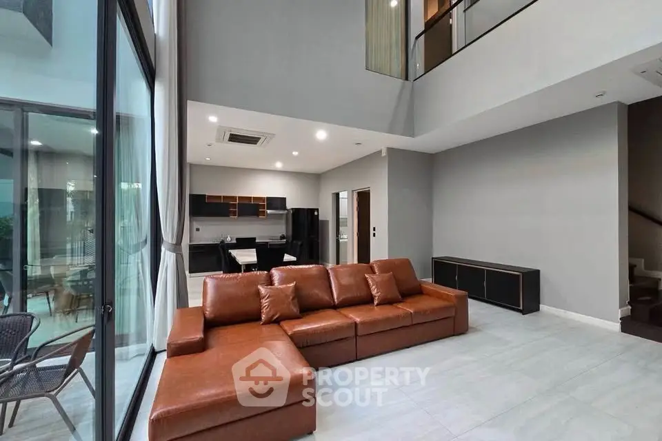 Spacious modern living room with high ceilings and open kitchen layout
