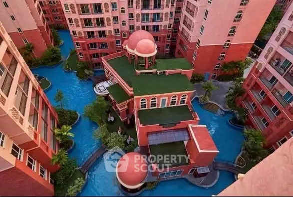 Stunning aerial view of unique residential complex with vibrant architecture and lush landscaping.